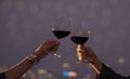 Romantic couple happy moment relaxing ,red,wineglass,celebration on the rooftop in the night with bokeh