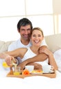 Romantic couple having breakfast lying in the bed Royalty Free Stock Photo