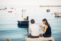 Romantic couple having relationship problems.Woman crying and begging a man.Fisherman life,dangerous occupation.Navy sailors Royalty Free Stock Photo