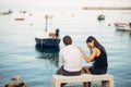 Romantic couple having relationship problems.Woman crying and begging a man.Fisherman life,dangerous occupation.Navy sailors Royalty Free Stock Photo