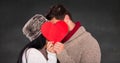 Romantic couple hiding their face behind heart Royalty Free Stock Photo