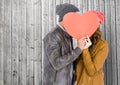 Romantic couple hiding their face behind heart Royalty Free Stock Photo