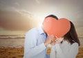 Romantic couple hiding their face behind red heart Royalty Free Stock Photo