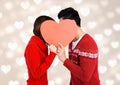 Romantic couple hiding their face behind red heart Royalty Free Stock Photo