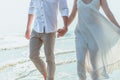 Romantic couple holding hands running and walking on beach. Man and woman in love. People travel concept Royalty Free Stock Photo
