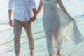 Romantic couple holding hands running and walking on beach. Man and woman in love. People travel concept Royalty Free Stock Photo