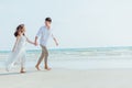 Romantic couple holding hands running and walking on beach. Man and woman in love Royalty Free Stock Photo