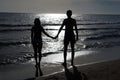 Romantic couple holding hands at sunset on the beach Royalty Free Stock Photo