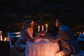 Romantic couple holding hands together over candlelight Royalty Free Stock Photo