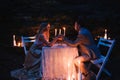 Romantic couple holding hands together over candlelight during r Royalty Free Stock Photo