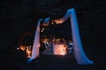 Romantic couple holding hands together over candlelight during romantic dinner outdoors. Royalty Free Stock Photo