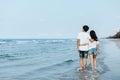 Romantic couple holding hands and walking on beach. Man and woman in love Royalty Free Stock Photo