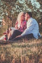 Romantic couple hugging while having picnic in sunset light Royalty Free Stock Photo