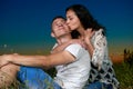 Romantic couple kiss on grass and ebmbrace on country outdoor, dark night sky, love concept, young adult people