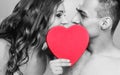 Romantic couple kissing behind red heart Royalty Free Stock Photo