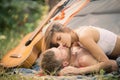 Romantic couple kissing on an camp near tent. Kissing lovers. Picnic couples.