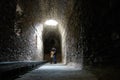 Romantic couple kissing on a dark ruin antique temple arab muslim church tunnel room with a hole where light comes through