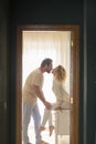 Romantic couple kissing at home - happy relationship man and woman indoor - husband and wife kiss with love and passion with Royalty Free Stock Photo