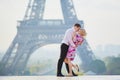 Romantic couple kissing near the Eiffel tower in Paris, France Royalty Free Stock Photo