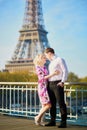 Romantic couple kissing near the Eiffel tower in Paris, France Royalty Free Stock Photo