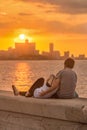 Romantic couple looking at a sunset in Havana