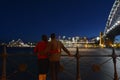 Romantic couple looks at Sydney skyline at dusk