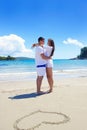 Romantic couple in love have fun on the beach with heart drawi Royalty Free Stock Photo