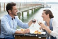 Romantic couple in love having dinner at sea beach restaurant Royalty Free Stock Photo