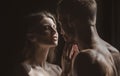 Romantic couple in love looking at each other, embracing and kissing on black background. Sensual couple kiss. I love Royalty Free Stock Photo