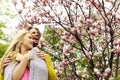 Romantic couple in love in spring garden at blooming magnolia Royalty Free Stock Photo