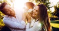 Romantic couple in love walking dogs in nature and smiling Royalty Free Stock Photo