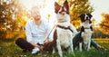 Romantic couple in love walking dogs in nature and smiling Royalty Free Stock Photo