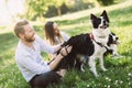 Romantic couple in love walking dogs in nature and smiling Royalty Free Stock Photo