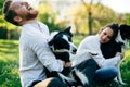 Romantic couple in love walking dogs in nature and smiling Royalty Free Stock Photo
