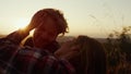 Romantic couple lying on grass in field. Loving woman touching man hair Royalty Free Stock Photo