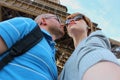 Romantic couple making selfie in front of Eiffel Tower while traveling in Paris, France. Students enjoy their vacation