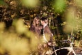 Romantic couple, man and attractive girl close together at tandem bicycle in dark autumn park. Royalty Free Stock Photo