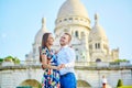 Romantic couple near Sacre-Coeur cathedral on Montmartre, Paris Royalty Free Stock Photo