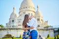 Romantic couple near Sacre-Coeur cathedral on Montmartre, Paris Royalty Free Stock Photo