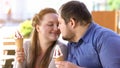 Romantic couple nuzzling holding sweet ice-cream in hands, diabetes risk Royalty Free Stock Photo