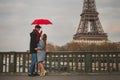 Couple in Paris near Eiffel tower in autumn, dating, man and woman kissing under umbrella Royalty Free Stock Photo