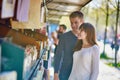 Romantic couple in Paris selecting a book from a bookseller Royalty Free Stock Photo