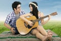 Romantic couple playing guitar together Royalty Free Stock Photo