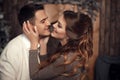 Romantic couple portrait in love. Cheerful Happy newlywed hugging in cozy wooden interior on winter holidays.