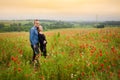 Romantic couple portrait in red poppy field Royalty Free Stock Photo