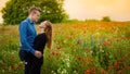 Romantic couple portrait in red poppy field Royalty Free Stock Photo