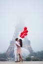 Romantic couple with red balloons together in Paris Royalty Free Stock Photo