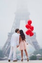 Romantic couple with red balloons together in Paris Royalty Free Stock Photo