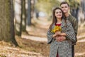 Romantic couple relaxing in autumn park, cuddling, enjoying fresh air and beautiful fall weather. Royalty Free Stock Photo