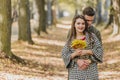 Romantic couple relaxing in autumn park, cuddling, enjoying fresh air and beautiful fall weather. Royalty Free Stock Photo